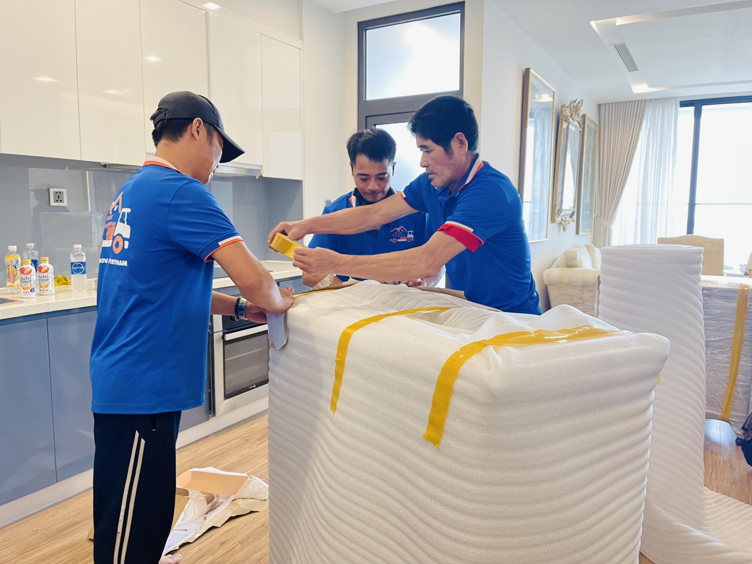 Hanoi Packers Movers crews wrap furniture before moving to Ho Chi Minh City 