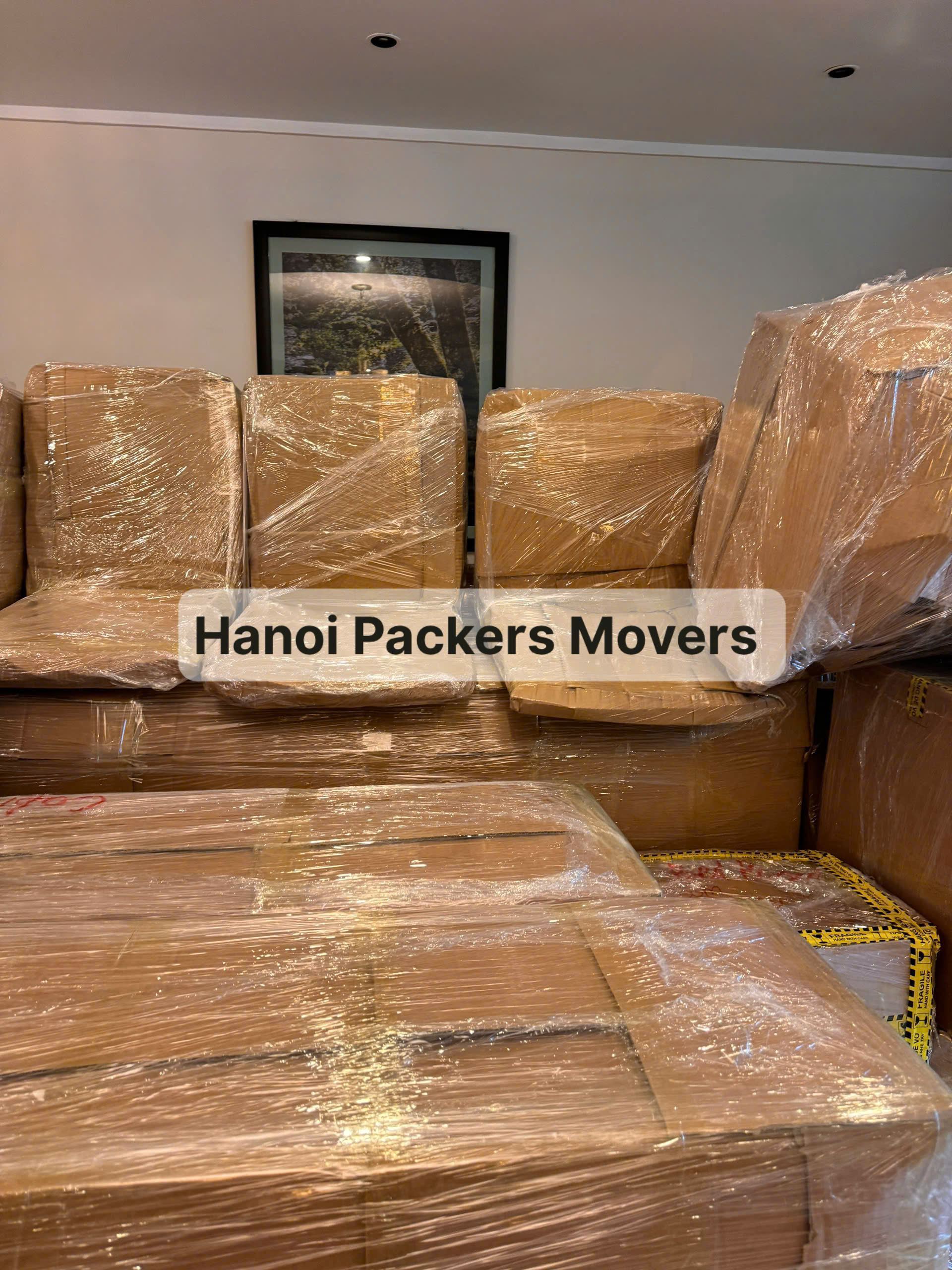 sofa and wooden furniture wrapped with bubble wrap and cardboard