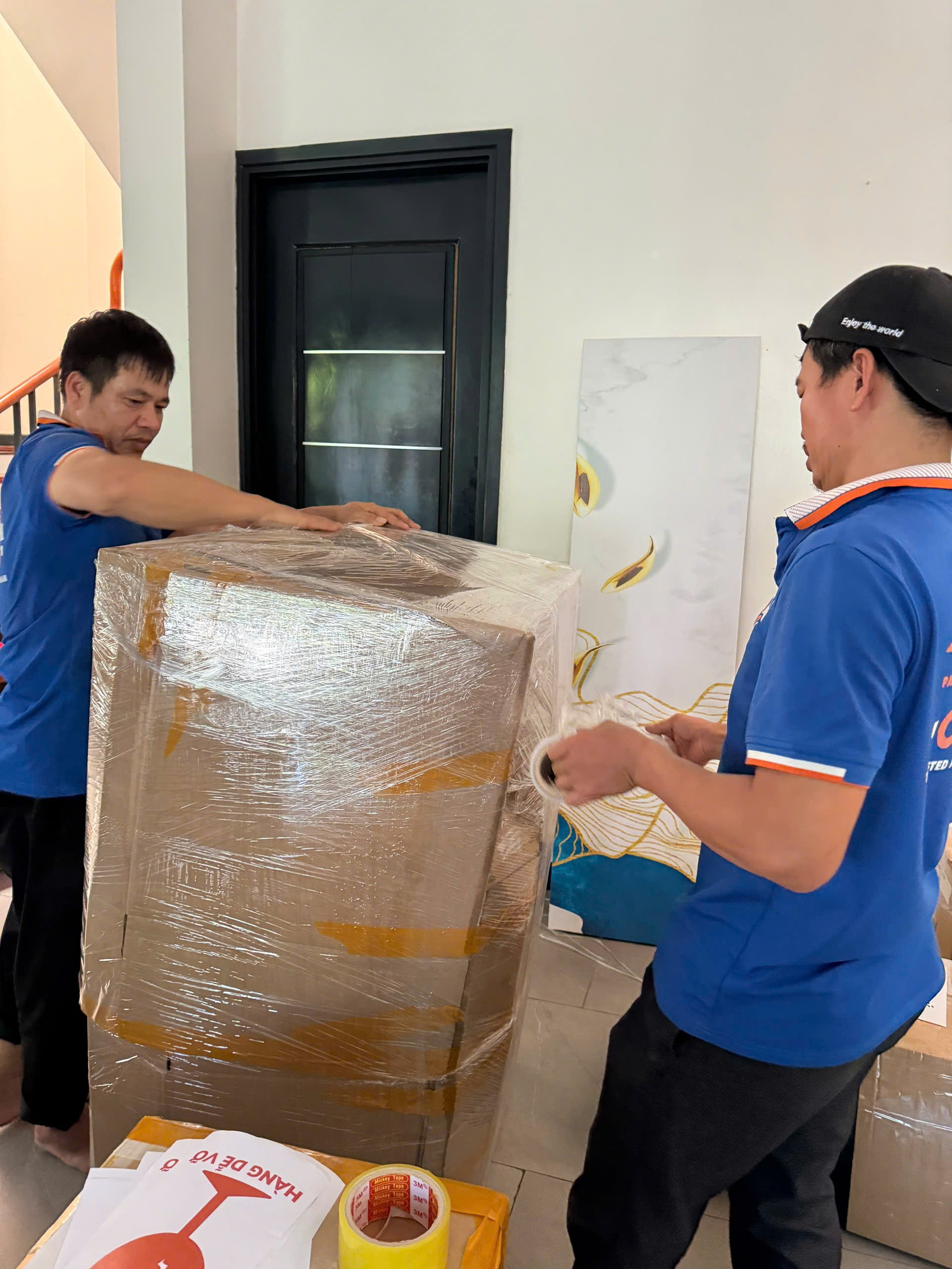 Professional movers packing household items with care